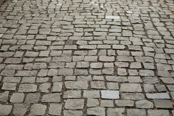 Grey ancient brick road texture background from square stones antique architecture paved footpath for walk 