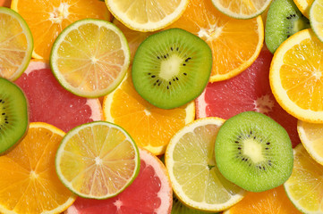 Fototapeta na wymiar Slices Background With Lemon, Kiwi, Orange, Tangerine