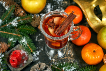Naklejka na ściany i meble Christmas hot drink mulled wine with fruit on a dark table .