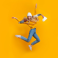 Cheerful winter girl enjoying her life, flying in the air
