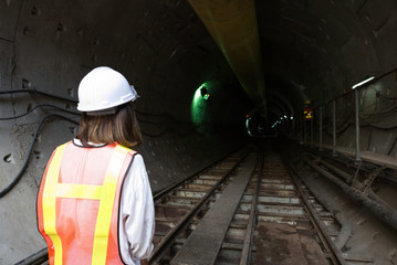 Fototapeta premium Engineer inspect concrete structures in tunnel construction for underground concept background for railway, train, job, transportation technology, construction technology, site manager,tunnel engineer