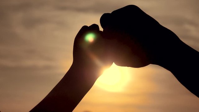 teamwork concept. of a human hand with bumping fist. Friends Friendship Fist Bump Togetherness Concept. father and son teamwork hands silhouette at lifestyle sunset