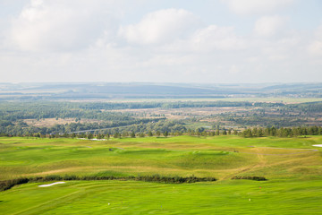 Aerial view of a green golf course, golf course on a sunny day