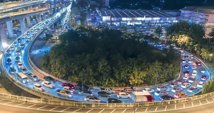 aerial view crowded traffic road roundabout in city at night, Time lapse road in bangkok thailand.