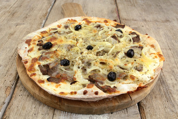 pizza with kebab and mozzarella on a wooden table