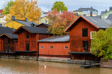 The granite embankment with red houses and barns. Beautiful autumn landscape. Historic centre. Porvoo, Finland