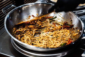chef cooking noodles in the restaurant