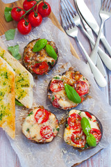 Grilled champignon portobello stuffed with mozzarella, cherry tomatoes and basil with garlic herb baguette