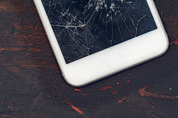 Mobile smartphone with broken screen close up