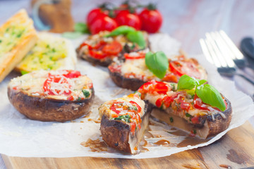 Grilled champignon portobello stuffed with mozzarella, cherry tomatoes and basil with garlic herb baguette