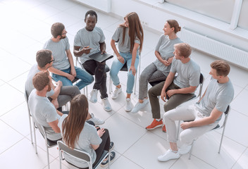 top view. discussion group of young people sitting in a circle