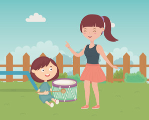 Obraz na płótnie Canvas woman and boy playing drum in the grass, kids toys