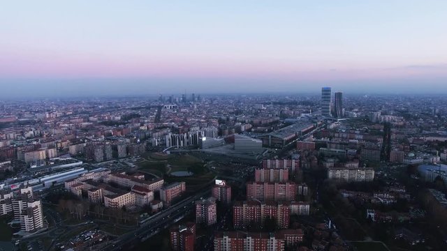 Milan, Italy. Aerial footage of the city during dusk time, with the skyscrapers in the mist.