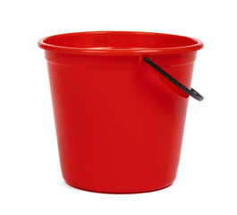 empty red plastic household bucket on a white background - obrazy, fototapety, plakaty