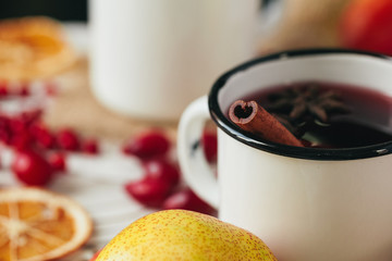 Autumn composition with hot mulled wine and spices on wooden background