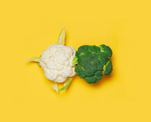Broccoli and cauliflower on yellow background. minimal vegetarian concept.