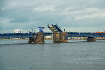 Aalborg, Denmark: Bascule bridge across the Langerak strait just opening for vessels, yacht board...