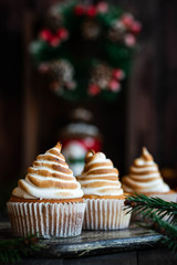 Citrus cupcakes with lemon curls and a cap from Swiss meringue