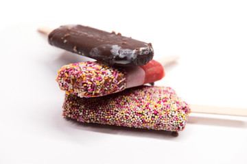 Set of ice cream on stick with colorful sprinkles isolated on white