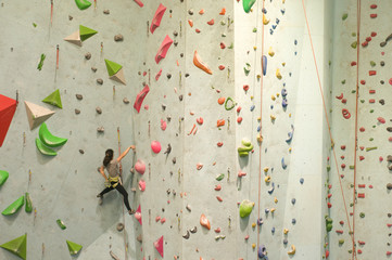 Girl climber training in climbing gym 