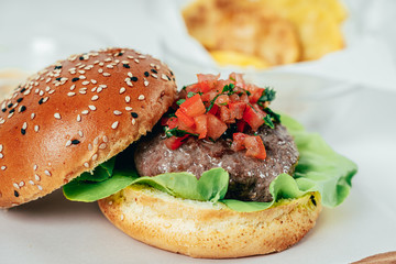 Beef Burger With Lettuce Salad, Tomatoes And Chips
