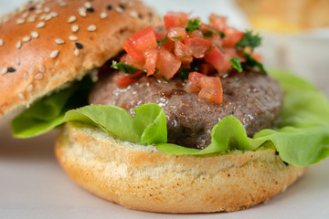 Beef Burger With Lettuce Salad, Tomatoes And Chips