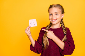 Close-up portrait of her she nice attractive sweet cute cheerful cheery pre-teen girl demonstrating note pad sticker emotion isolated over bright vivid shine vibrant yellow color background