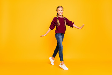 Full length body size view of nice attractive charming lovely cheerful cheery girlish carefree pre-teen girl strolling isolated over bright vivid shine vibrant yellow color background