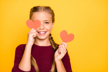 Obraz na płótnie Canvas Close-up portrait of nice attractive charming lovely cheerful cheery positive pre-teen girl closing eye with heart card joke isolated over bright vivid shine vibrant yellow color background