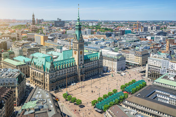 Beautiful aerial view of historic city center of hanseatic Hamburg with famous town hall at market square and ancient harbour district in the background on a sunny day with blue sky in summer, Germany