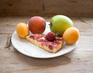 Round strawberry pie with fresh strawberries slice on plate dish on wooden table background