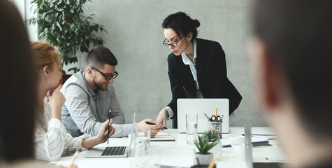 Creative people analyzing data on meeting in office