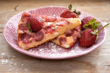 Round strawberry pie with fresh strawberries slice on plate dish on wooden table background