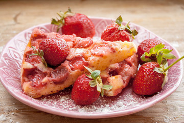 Round strawberry pie with fresh strawberries slice on plate dish on wooden table background