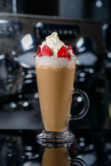 Iced coffee with milk and whipped cream and strawberries