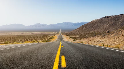 Foto op Plexiglas Beautiful panoramic view of a long straight road cutting through a barren scenery of the wild American Southwest with extreme heat haze on a hot and sunny day with blue sky in summer © Shambhala