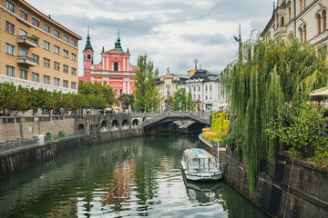 Fototapeta na wymiar Beautiful panoramic view of scenic Ljubljana city center with famous Triple Bridge, the historic Franciscan Church of Annunciation and idyllic Ljubljanica River on a moody day in summer, Slovenia
