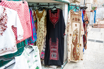 Dresses with traditional oriental and arabic ornament sold on a market in Jerusalem