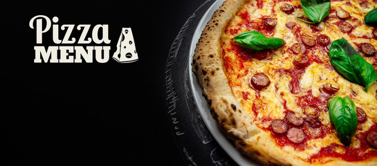 Italian pizza on a dark background. Copy space for text. Banner composition