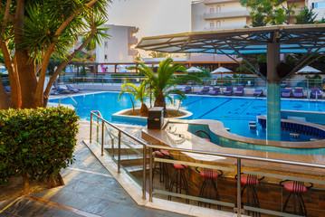 resort area with swimming pool, palm trees, sunset, Europe, Greece, Rhodes.