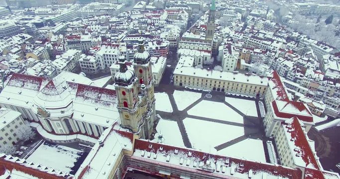 St. Gallen, Switzerland - Amazing drone footage of the historical city of Saint Gallen in north Switzerland, with the old town and churches covered in snow.