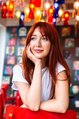 Portrait of sitting girl propping cheek by hand
