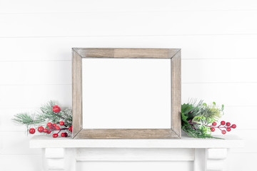Rough wooden frame on a light background with branches of greenery