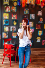 Full length shot of girl listening to musicin cafe