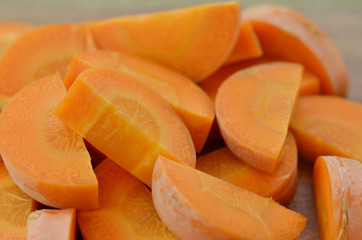 Fresh sliced carrots on a wooden background