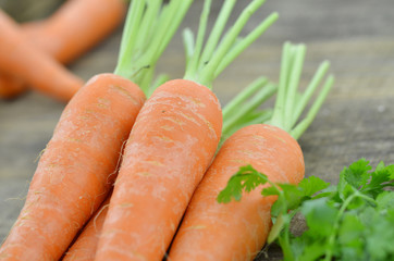 Tasty ripe carrot on wooden background
