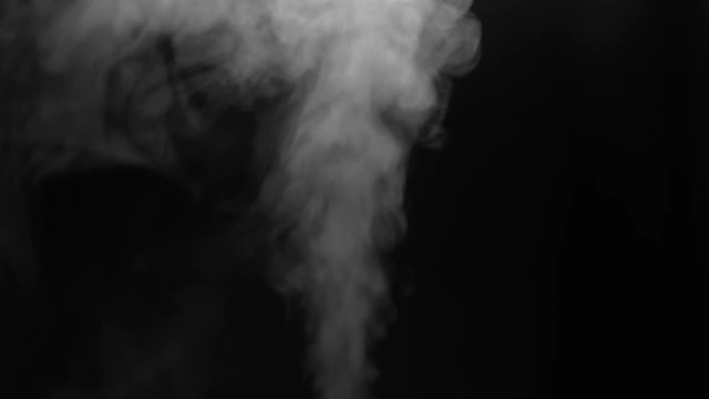 Close up of white steam smoke shot up on a black background. Concept of abstract backdrop.