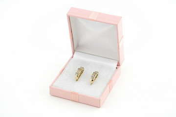 pair of yellow gold earrings in a box