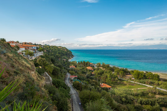 Beautiful sunny seashore, blue sea water and clear sky, horizon line. Afitos, Chalkidiki, Greece. Horizonal color photography.