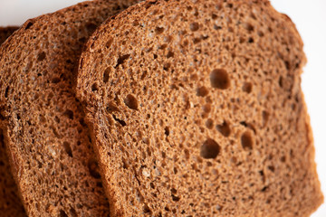 Sliced black bread with on white background.